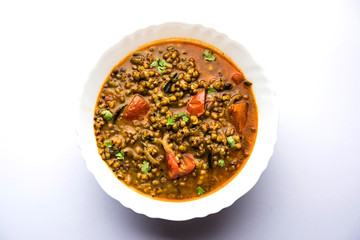 Whole Green Moong Dal fry / Whole Mung bean Tadka served in a bowl. selective focus