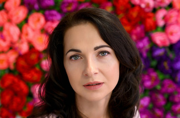 Naklejka premium Close-up portrait of an adult pretty brunette woman on color background in studio. Beauty, Art, model posing.