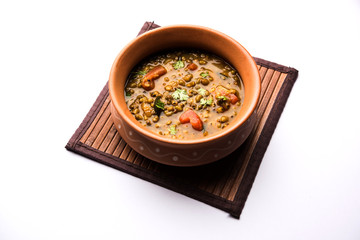 Whole Green Moong Dal fry / Whole Mung bean Tadka served in a bowl. selective focus