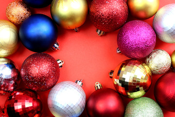 Christmas toys in the form of a ball are located on a red background.