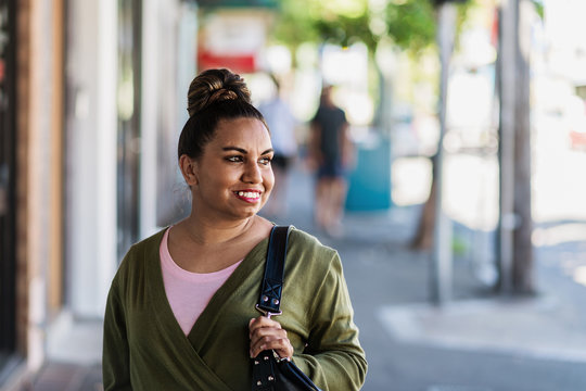 aboriginal woman walking on the footpath
