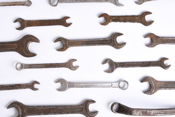 Old rusty stainless steel crescent wrench isolated on white top view