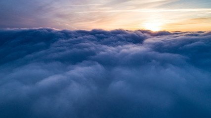 Obraz premium Magical view of cumulus clouds in winter at sunset