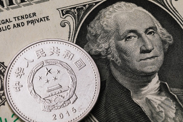 Yuan against the background of 1 dollar bill