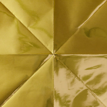 Close up of folded gold origami paper
