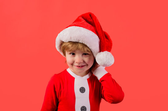 Santa helper. Elf. Little klid in Santa costume. Santa Claus. Gifts. New Year. Happy New Year. Christmas kids. Holiday. Kid in santa hat. Christmas. New year kid. Close up.