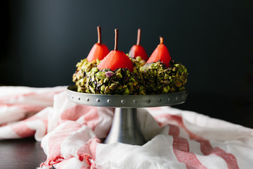 Elegant poached pears with a dark chocolate and pistatchio coati