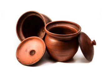 Empty clay pots on a white isolated background close-up. Set of clay pots.