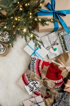 Under the christmas tree: presents, a jumper and snowball glasses