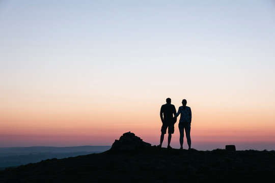Couple admiring the view at twilight from Little Longstone, Derb