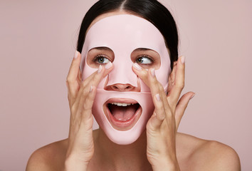 Stunning woman using gel facial mask