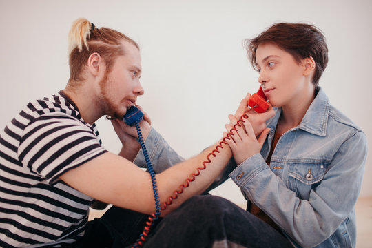 Man and woman speaking on telephone