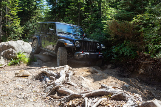 Mission, British Columbia, Canada - August 6, 2018: Jeep Rubicon is riding thru rough and rugged terrain to the lake.