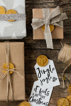 Diy christmas gifts wrapped with starry and kraft paper with hand written cards and golden chocolate coins