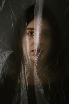 Woman behind blurry plastic
