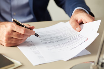 Manager in suit reading paper document