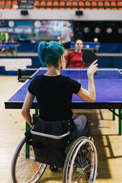Woman in wheelchair playing table tennis