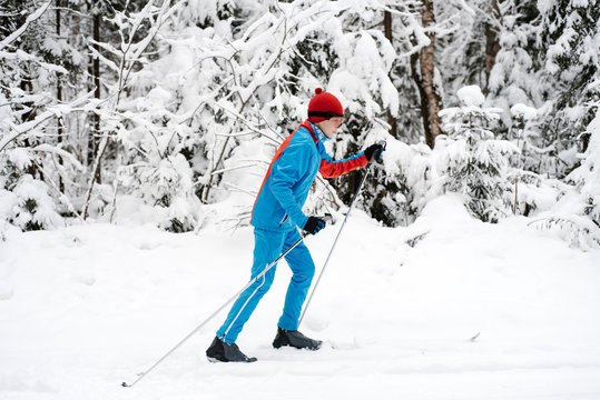 Teenager skiing near conifer trees