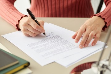 Faceless woman putting personal signature