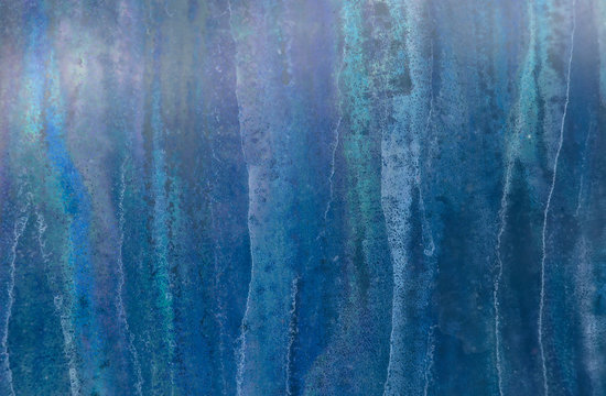 A virtual abstract 'forest' of iridescent tree trunks, actually dripping bacteria patterns between the panes of an exterior commercial glass door.