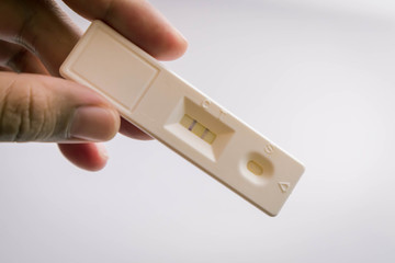 Asian hand woman holding and showing positive pregnancy tests with happiness She is about to conceive a baby, a new member of the upcoming family, the family is being filled.