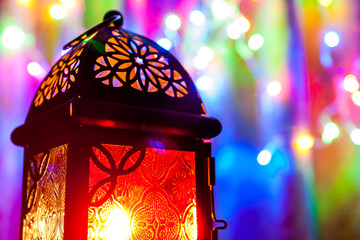 Arabic lantern in colorful illuminated background. Ramadan, Eid concept