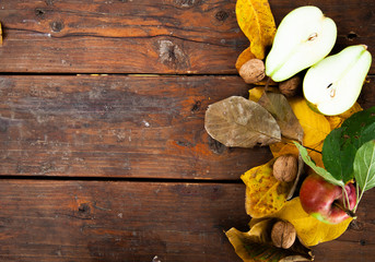Autumn still life with cup of tea, plaid and leaves on wooden background
