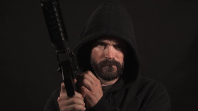 Hooded Man In Black With High Powered Rifle