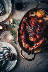 Traditional festive roasted turkey. Thanksgiving celebration in November. Christmas festive family dinner. Festive holiday season. Table setting decoration on holiday season