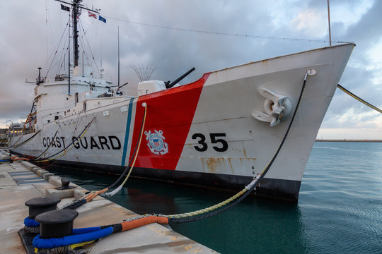 Key West, Florida, United States - November 2, 2018: View of Coast Guard Ship Destroyer at Truman Waterfront Park during a cloudy sunrise.