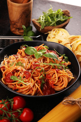 Plate of delicious spaghetti Bolognaise or Bolognese with savory minced beef and tomato sauce garnished with parmesan