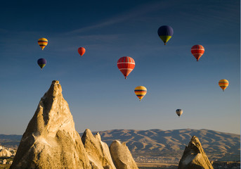 Hot air balloons flying over Goreme valley at sunrise, Cappadocia, Turkey