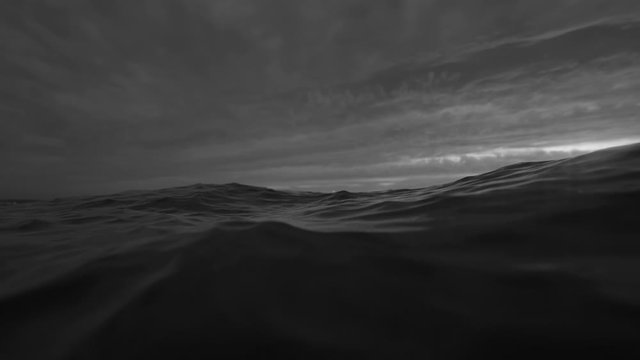 Sea or ocean wave close up, low angle view, slow motion shot. Black and white exotic background
