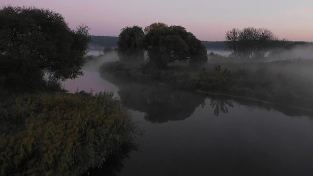 Beautiful low drone flight down by river on sunrise.
