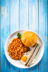 English breakfast - toast, egg, sausages and vegetables