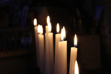 Row of lit candles on offer to the cult of the Virgin Mary (Madonna), in the cave of the sanctuary of the Mentorella, in Guadagnolo. Rome, Lazio, Italy. Sacred place of prayer, peace and silence.
