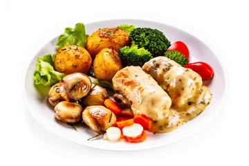 Wrapped pork chop with baked potatoes and vegetables