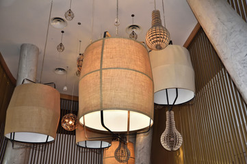 electric lamps with fabric lampshade under the ceiling of the building