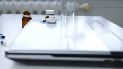 Image from Interior Office with a Laptop and Few Medical Pills 