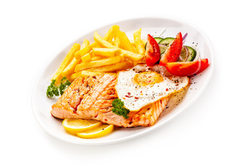 Fried salmon, French fries and vegetables