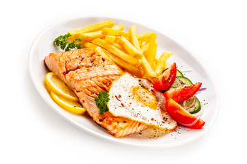 Fried salmon, French fries and vegetables