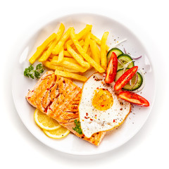 Fried salmon, French fries and vegetables