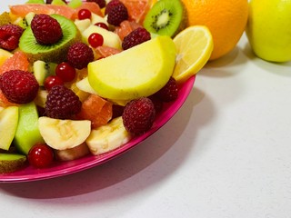 Sliced seasonal fruits in a plate.
