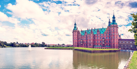 Obraz premium beautiful landscape with largest Renaissance castle in Scandinavia Frederiksborg slot Castle near Copenhagen. Hillerod, Denmark. Exotic amazing places. Popular tourist atraction.