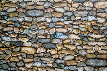 View of a wall of stones of irregular shapes, Backgrounds textures for graphic design. Wallpaper Abstract illustration of a natural stone.