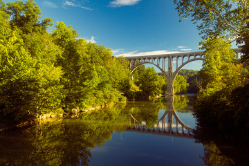 Fototapeta na wymiar Arch bridge spanning a river in Cuyahoga Valley National Park