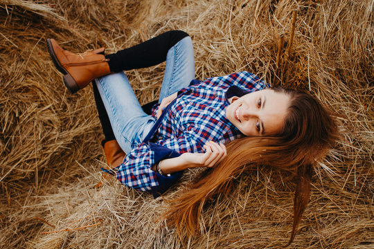 Beautiful Russian young woman lies in a haystack