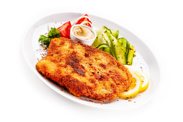 Fried pork chop and vegetable salad on white background
