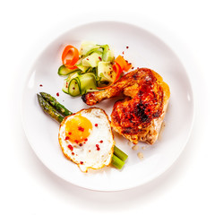 Fried egg with asparagus and chicken legon white background