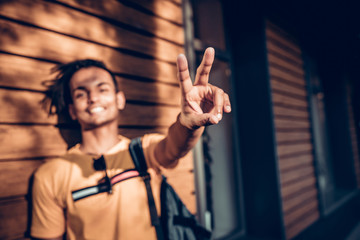 Indian young man doing a victory sign